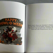Open book with a Halloween-themed illustration of a dog in a costume and text.